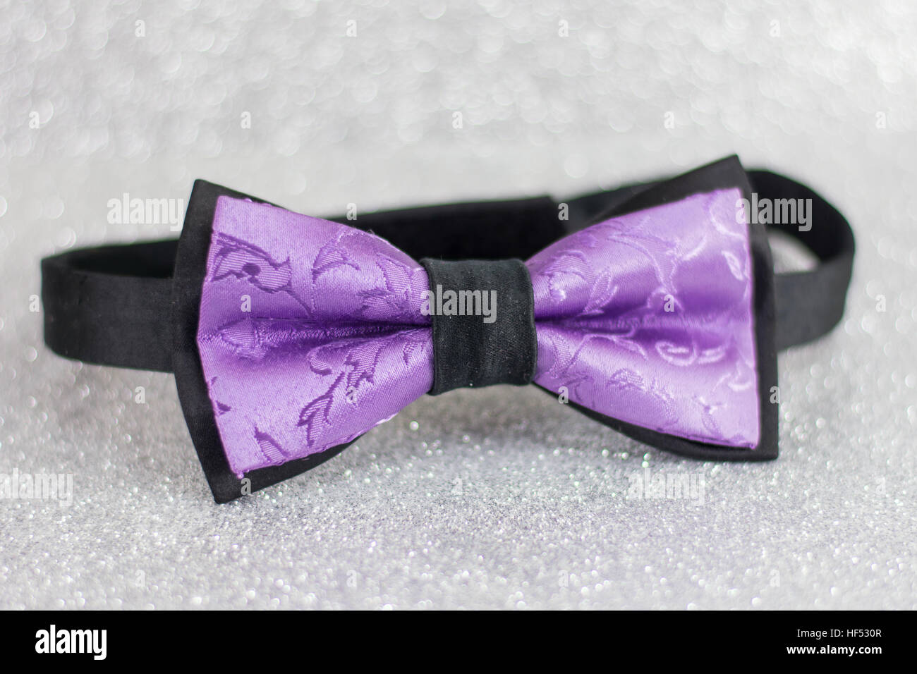 Noeud papillon violet sur fond brillant argent Banque D'Images