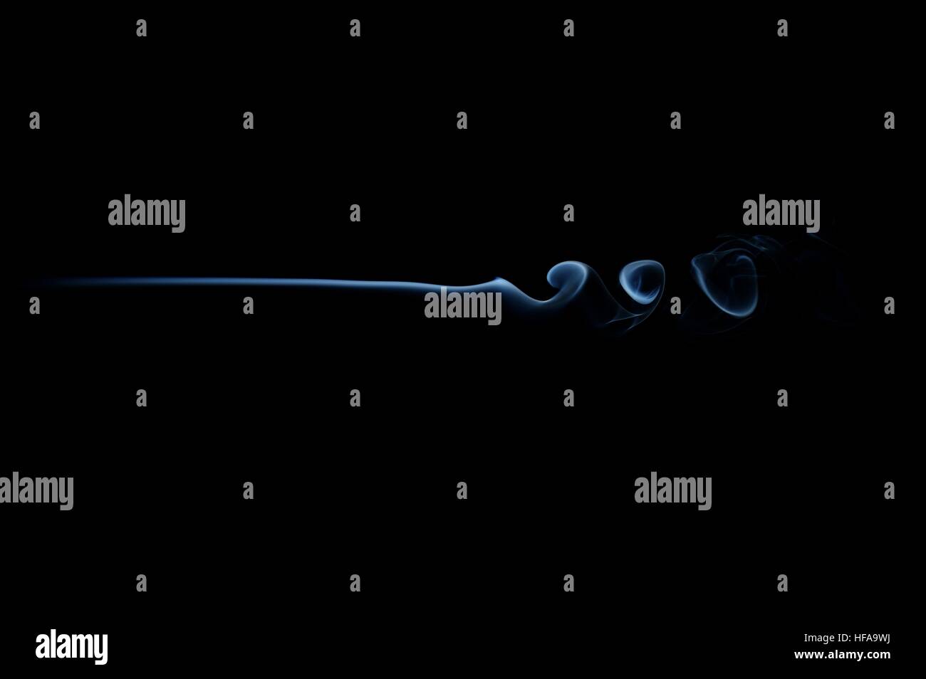 Vague de fumée bleue isolée sur le noir.Sentier de fumée bleu isolé sur noir.Onde de fumée horizontale. Banque D'Images