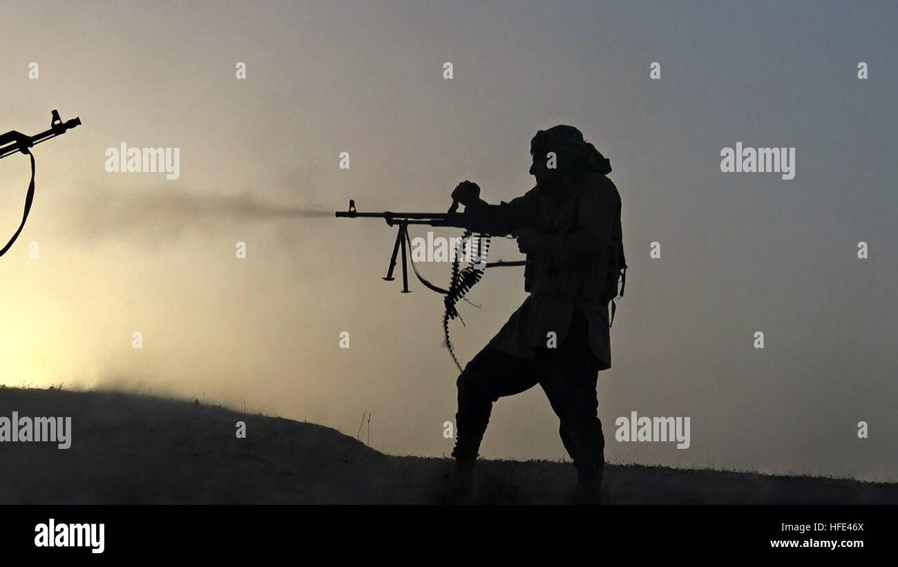 Image tirée d'un vidéo montrant la propagande ISIS militants tir à l'État islamique light machine gun au coucher du soleil durant un échange de tirs sur la rive ouest du Tigre dans la province de Salaheddine, le 28 juin 2016 près de Shirqat, de l'Iraq. Banque D'Images