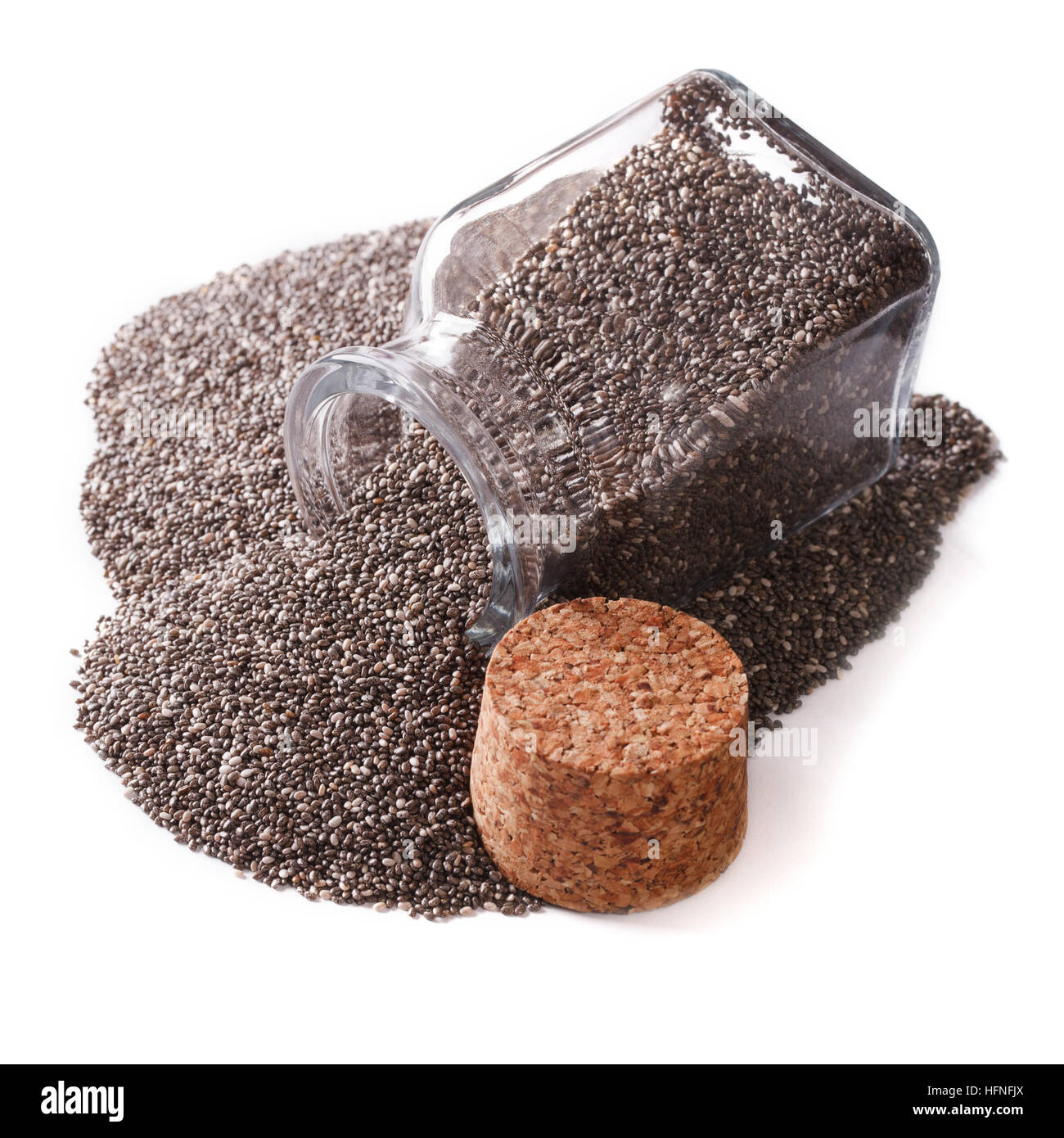 Les graines de Chia soigneusement sélectionnés renverse un pot de verre close up isolé sur fond blanc Banque D'Images