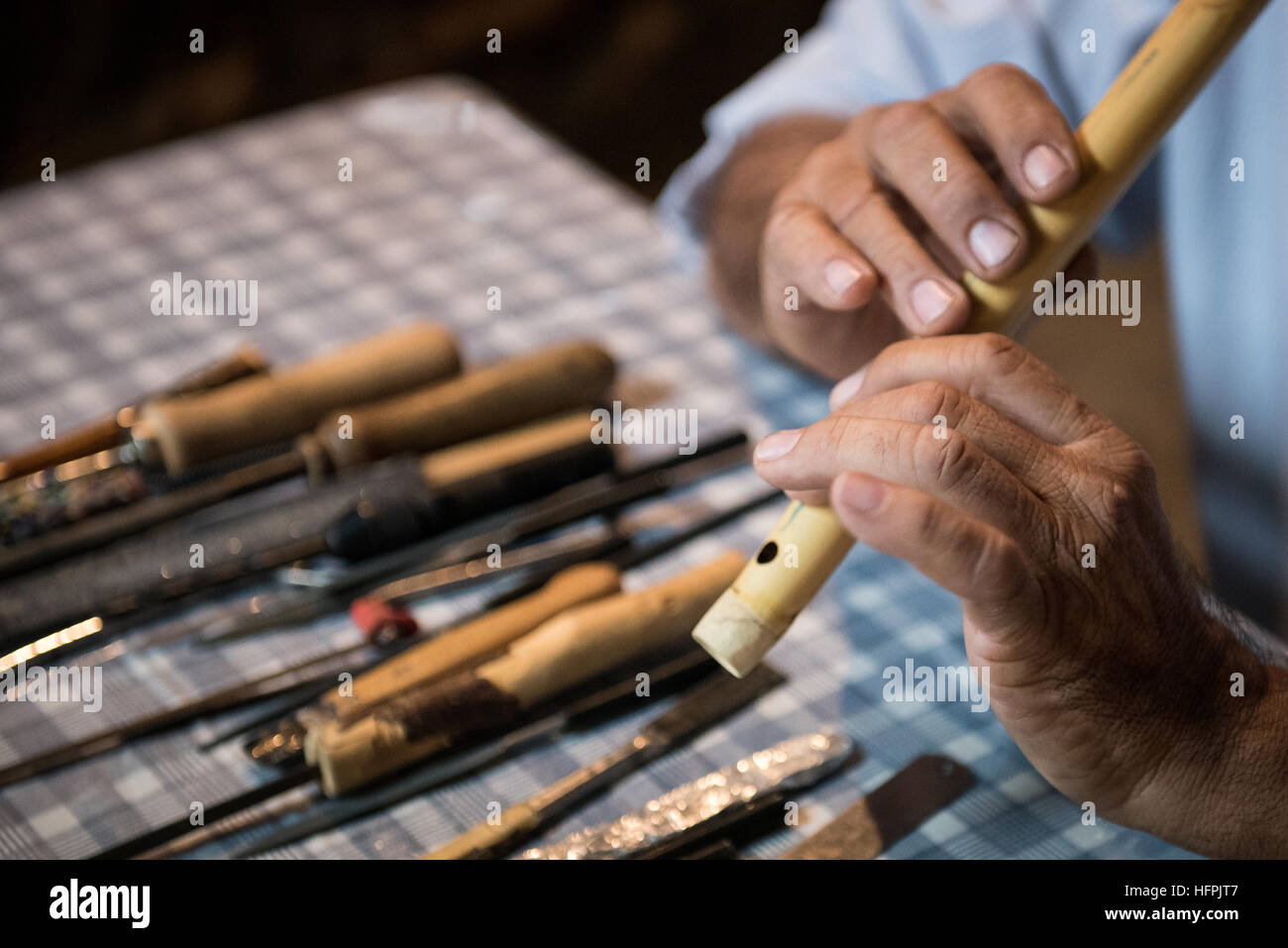 Man l'élaboration et la lecture d'un instrument de musique traditionnel de Chypre fait main appelé fogera. Banque D'Images