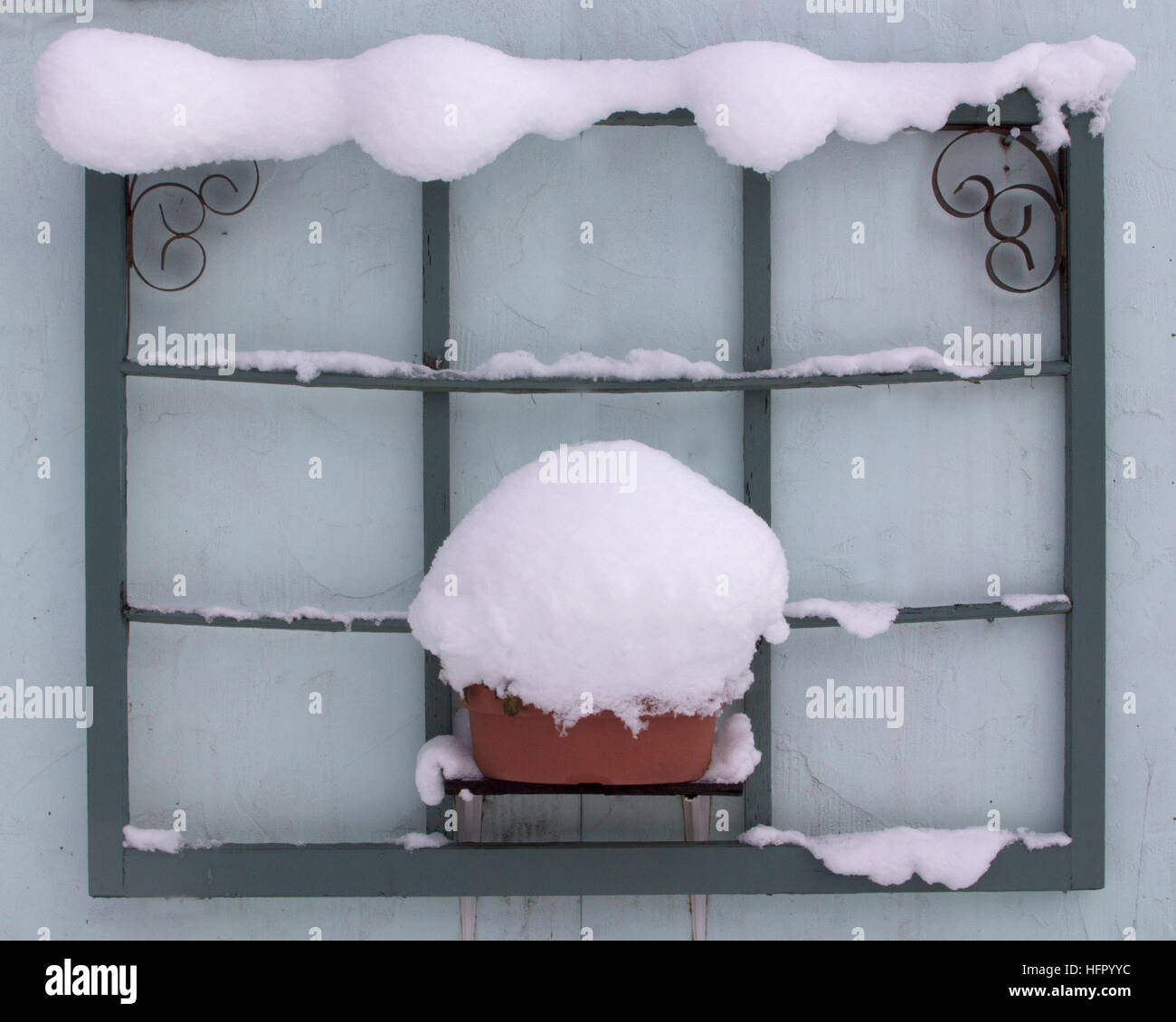 L'ancien cadre décoratif de fenêtre utilisé pour l'art de cour est bordé de neige Banque D'Images