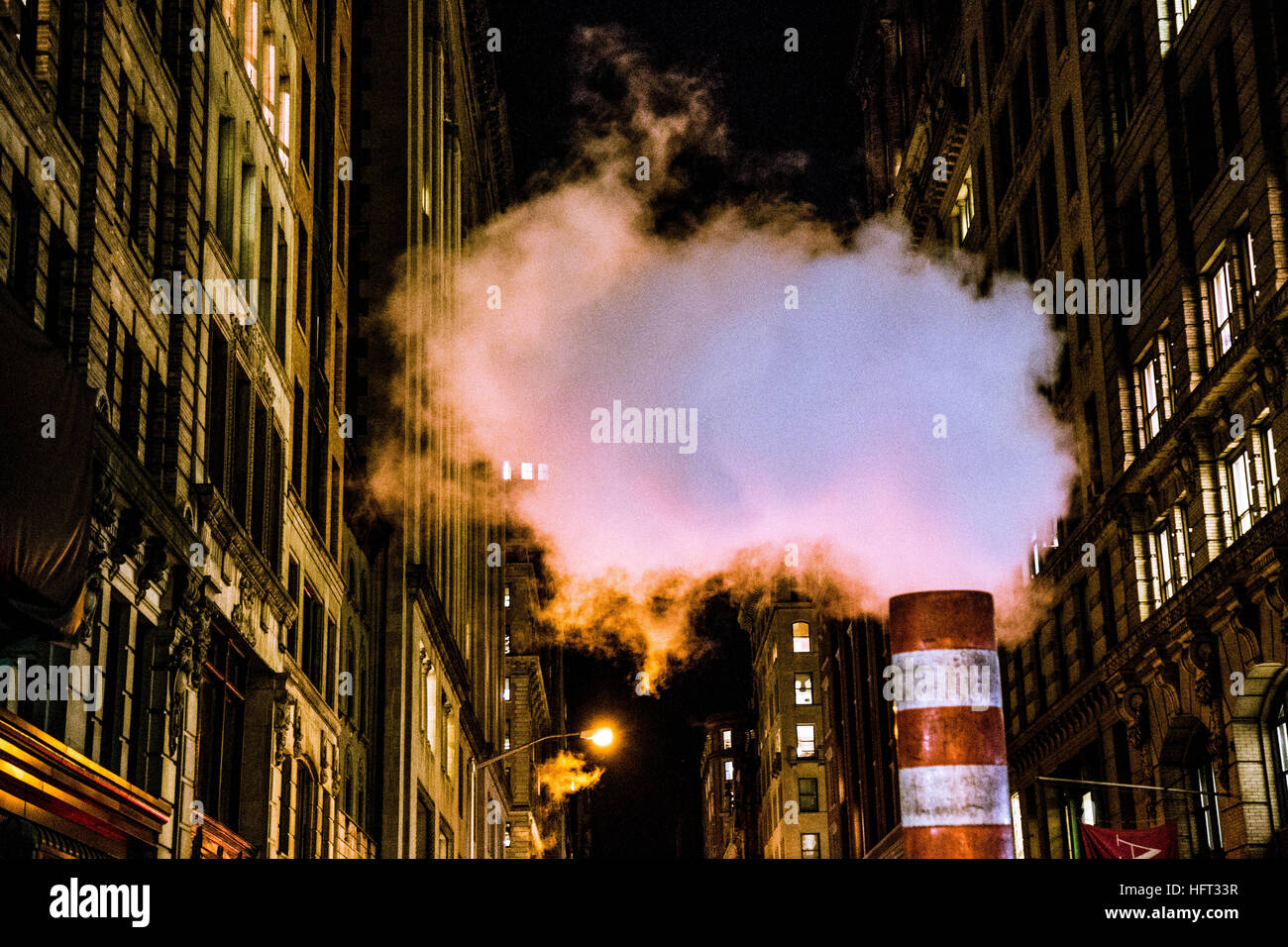 La fumée s'élevant dans le ciel de nuit dans une rue de Manhattan Banque D'Images