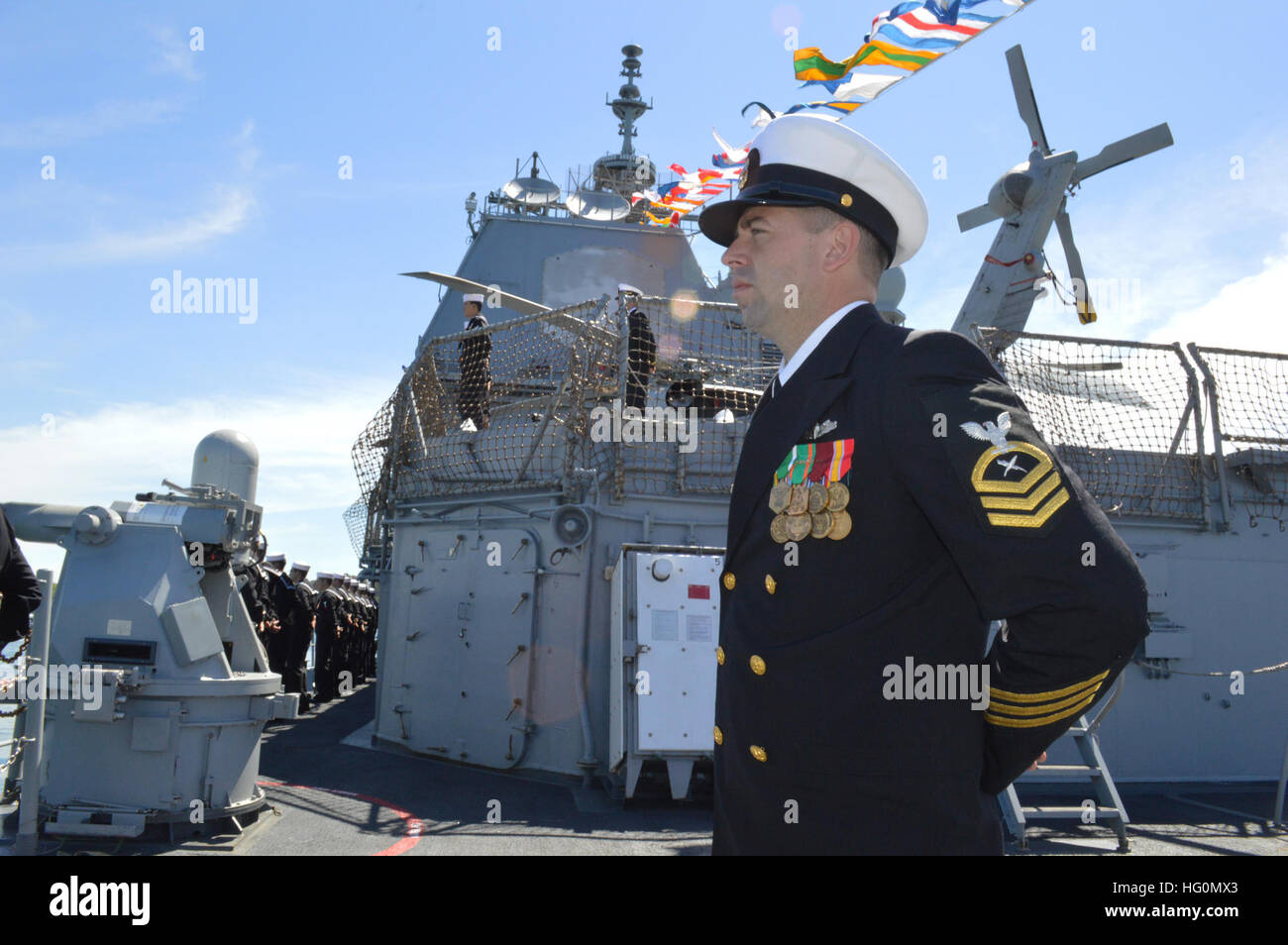 Avec un navire entièrement habillé et banderoles, premier maître de Matt Mistove et d'autres marins affectés à l'USS (CG 65) de Chosin homme les rails pendant qu'ils attendent du col et de l'examen dans le port de Sydney. L'équipage participe avec 20 autres marines mondiales dans le cadre de la Revue internationale de la flotte - le 100e anniversaire de la Marine royale australienne à Sydney. En ce moment est de Chosin opérant dans la zone de responsabilité de la 7ème flotte d'effectuer des exercices, des visites portuaires et maritimes afin de renforcer les partenariats et promouvoir la paix et la stabilité dans la région du Pacifique-Indo-Asia. (U.S. Photo par Marine Banque D'Images