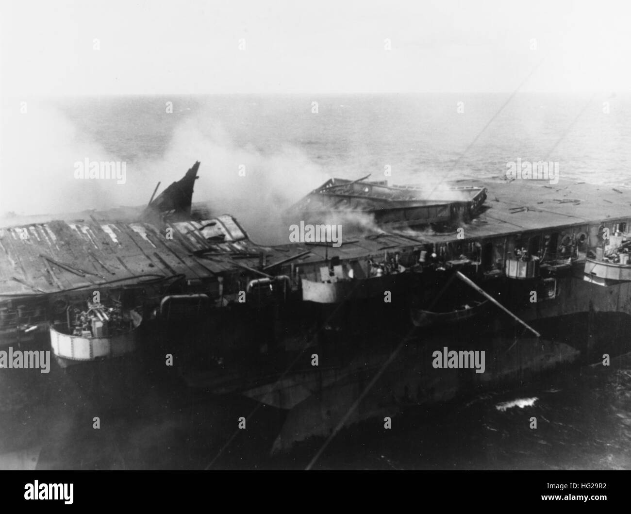 Vue de Princeton's après du côté bâbord et d'envol, vu de l'USS Birmingham (CL-62) qu'elle était arrivée aux côtés d'aider à combattre les incendies au cours de l'après-midi du 24 octobre 1944. Note de l'élévateur d'avions soufflé hors de position et à l'envers, et d'envol bouclée par le pont des explosions qui ont suivi une bombe a frappé japonais. Les navires sont exploités au large des Philippines. Photographie de la Marine américaine officielle, aujourd'hui dans les collections des Archives nationales. USS Princeton (CVL-23) endommagé 2 Banque D'Images