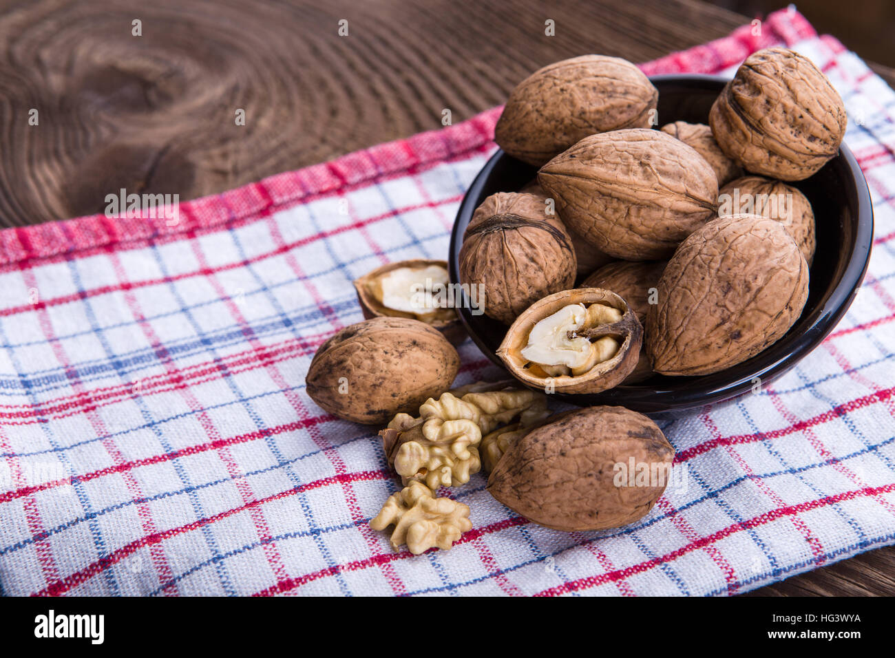 Les cerneaux de noix entiers et sur la vieille table de bois et torchon Banque D'Images