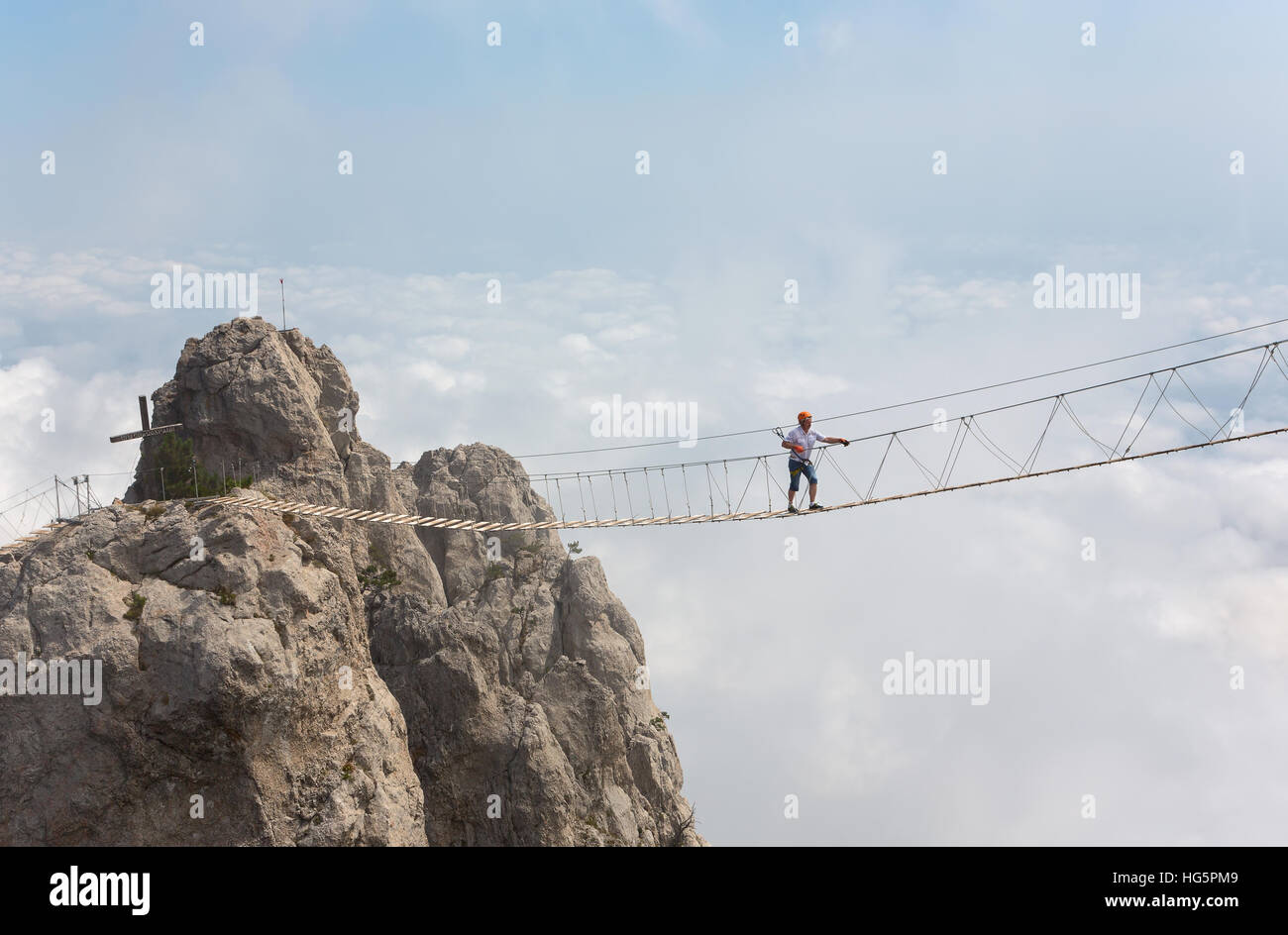Man Crossing the Chasm sur le pont suspendu Banque D'Images