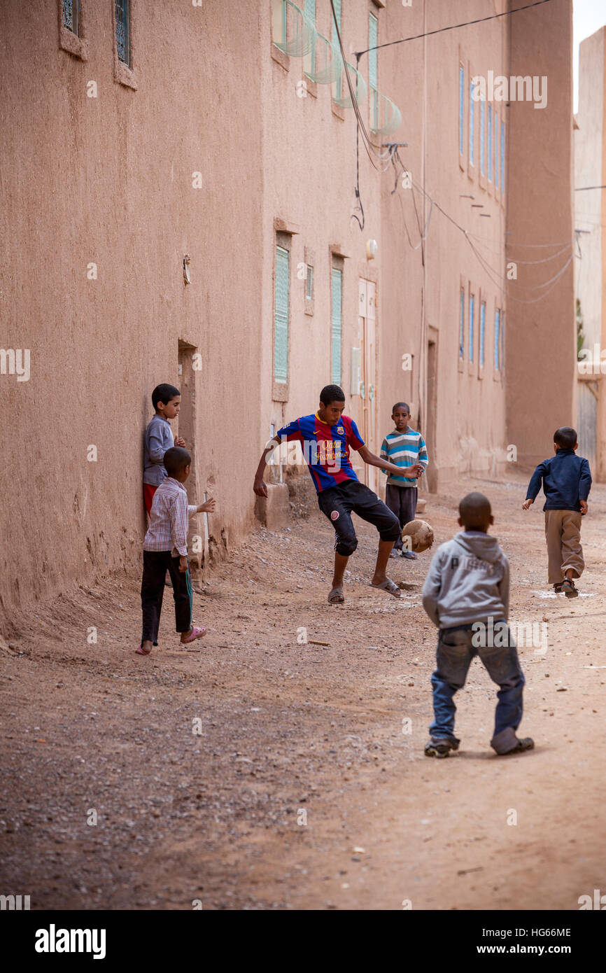 Elkhorbat, Maroc. Garçons jouant au football dans la Casbah. Banque D'Images