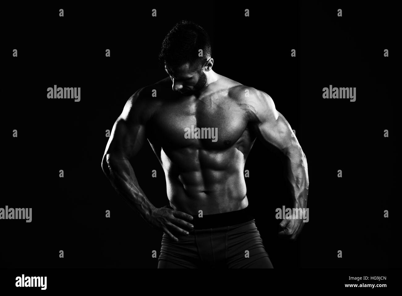 Homme en bonne santé Soyons forts dans la salle de sport et Flexing Muscles musculaire - Fitness Model Posing Bodybuilder athlétiques exercices après Banque D'Images