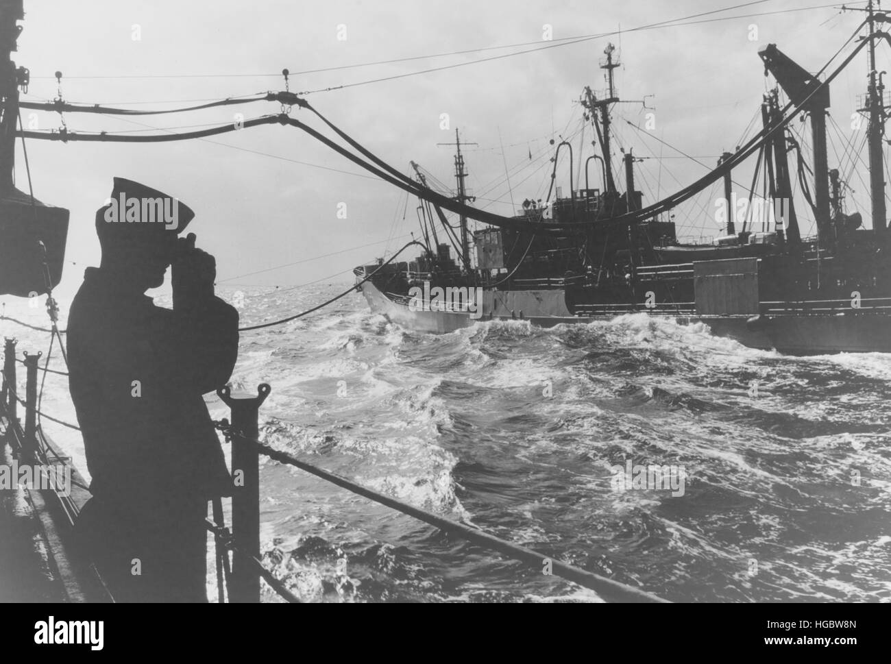 Un homme d'équipage s'enclenche une photo de USS Elokomin lors du ravitaillement avec USS Little Rock. Banque D'Images