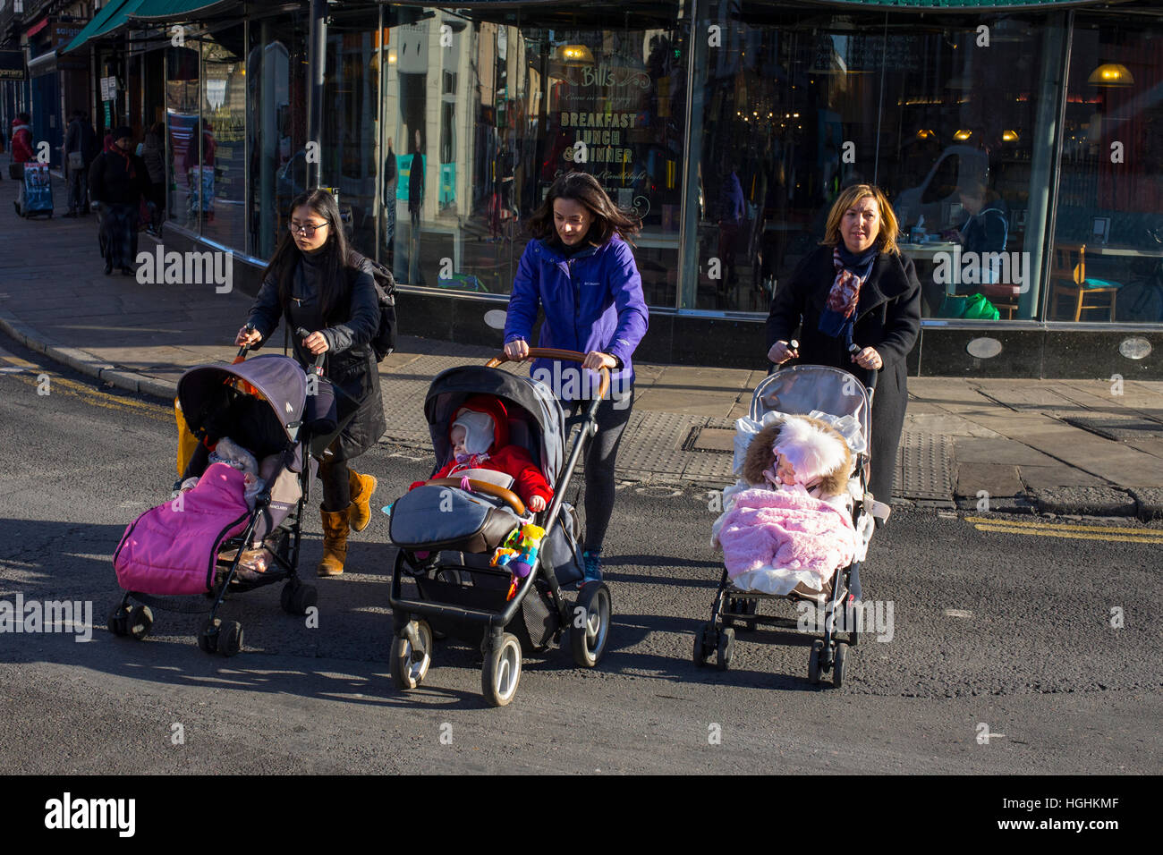 Les femmes à marcher avec des enfants en poussette Banque D'Images