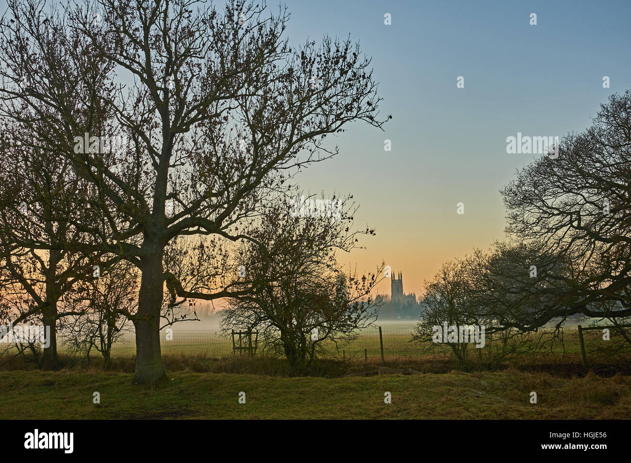 Coucher du soleil d'hiver et misty paysage avec une vue d'ensemble vers l'église du village de Hampton Lucy Banque D'Images