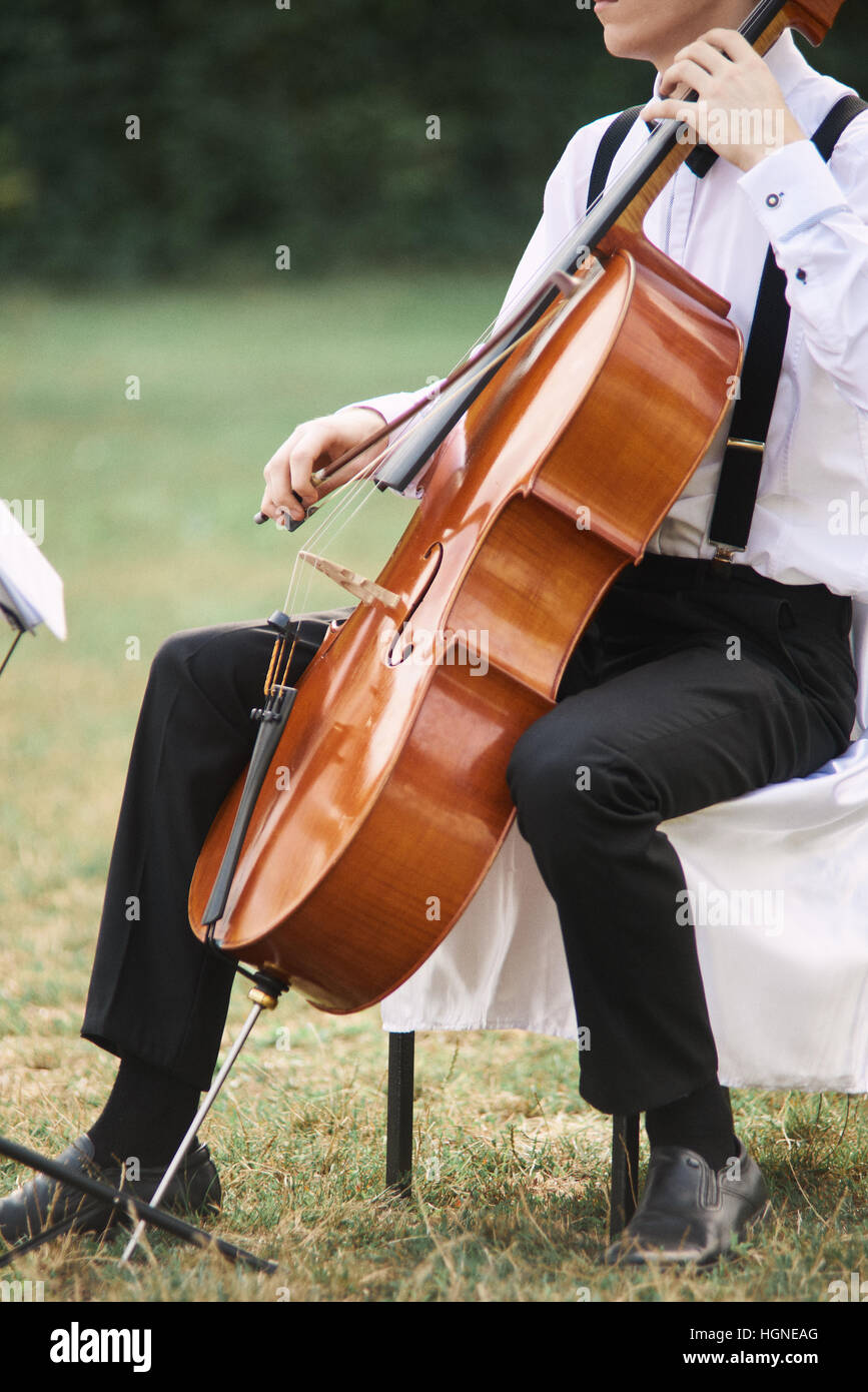 Jeune homme jouant du violoncelle à l'extérieur. Le violoncelliste jouant  la musique classique au violoncelle Photo Stock - Alamy