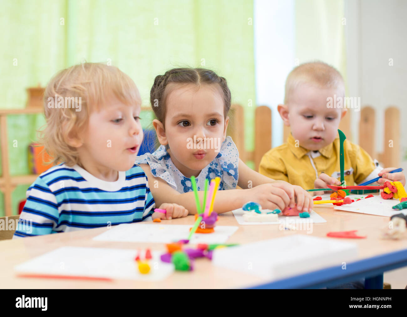 Les enfants faisant un gâteau au centre de jour Banque D'Images