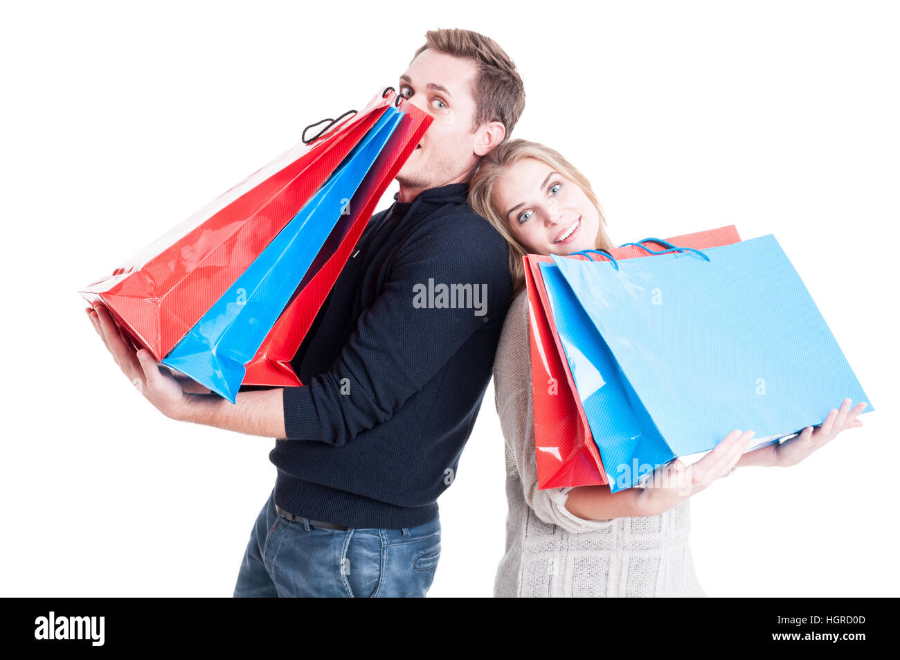 Heureux couple holding shopping bags lourd et d'action ludique et joyeuse isolé sur fond blanc Banque D'Images