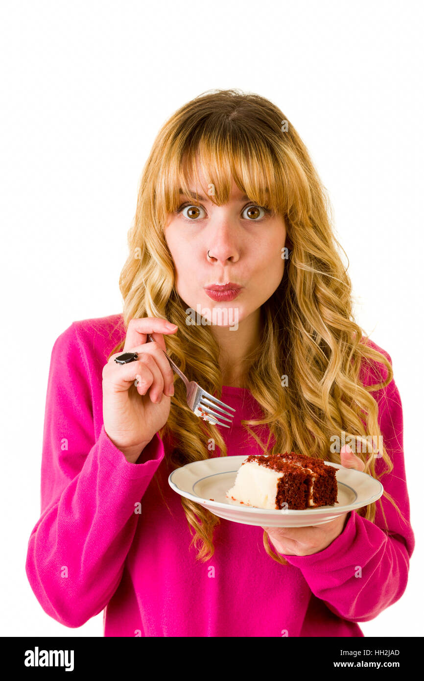 Une jolie blonde woman enjoying un morceau de gâteau Banque D'Images