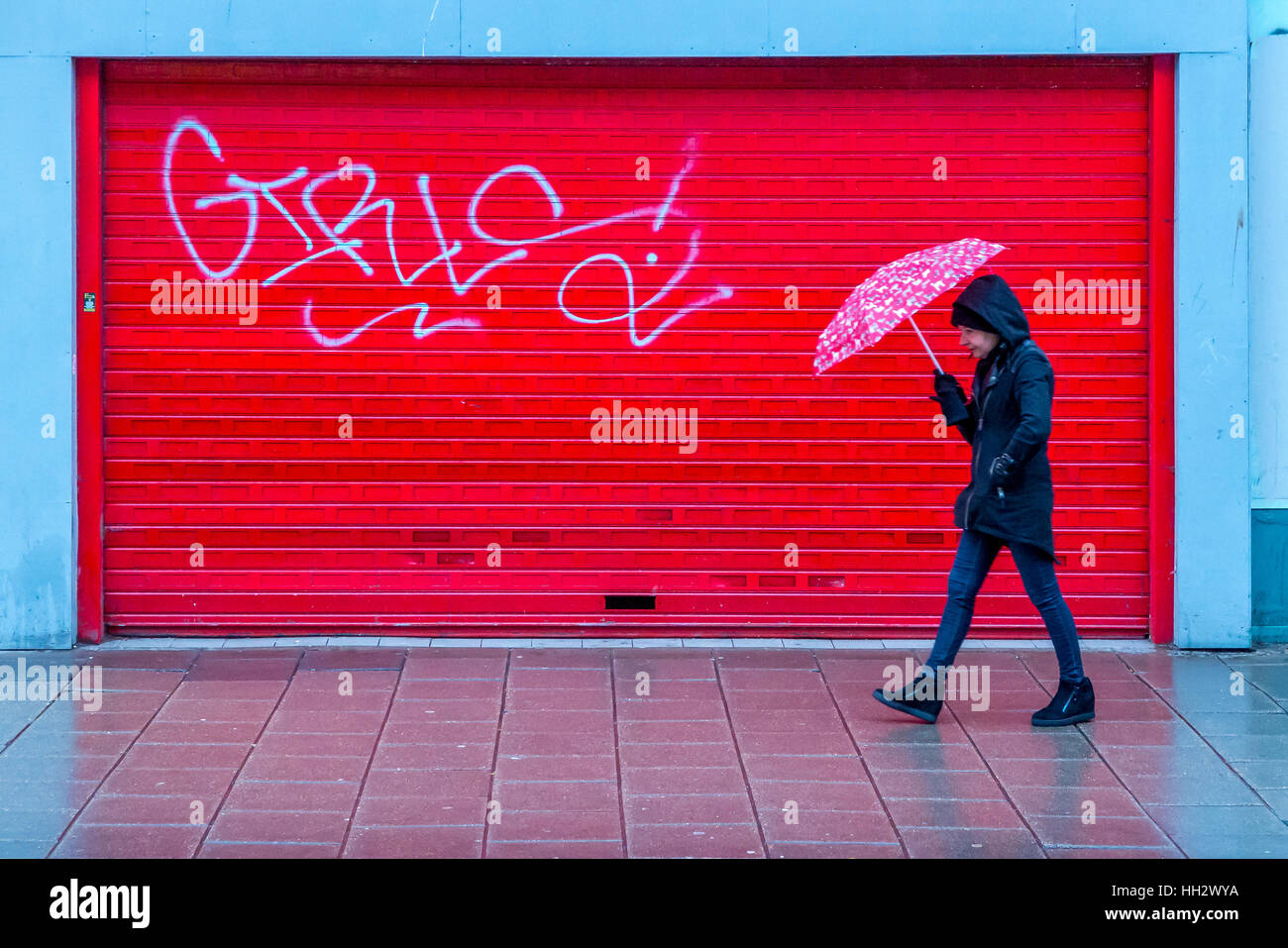 Brighton, UK. 14 janvier, 2017. Un piéton marche dans la pluie en bas de la principale rue commerçante à Brighton, passé jusqu'à bord d'unités commerciales Crédit : Andrew Hasson/Alamy Live News Banque D'Images