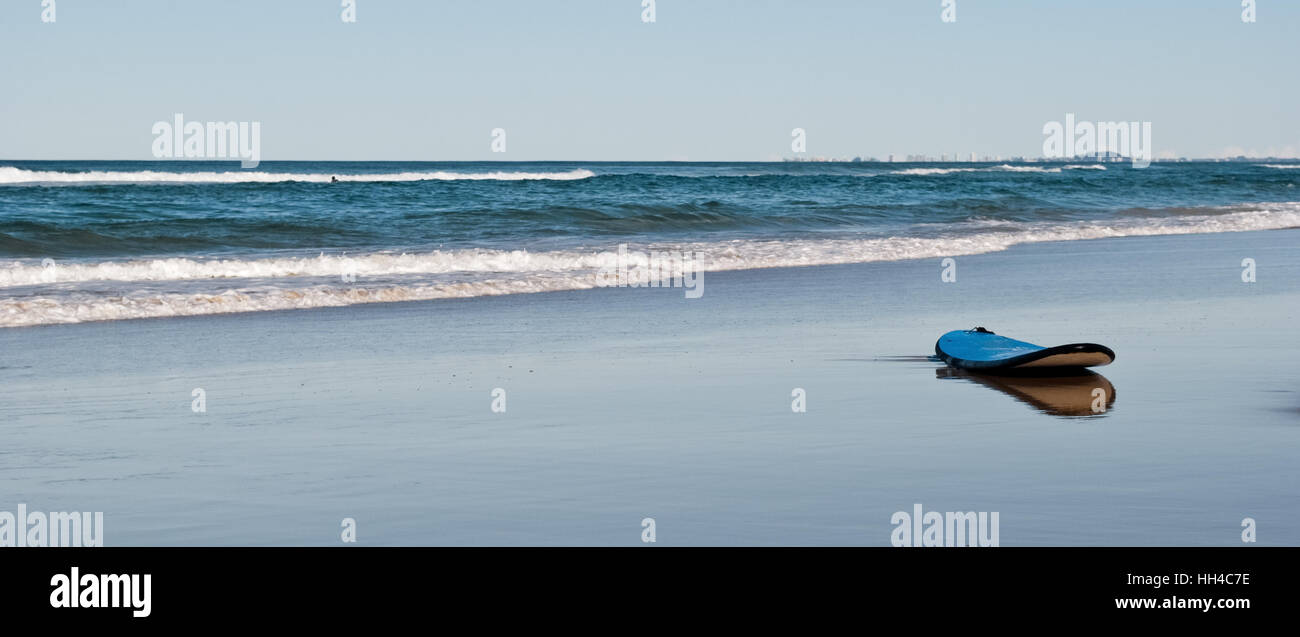 Planche de surf sur un estran désert Banque D'Images