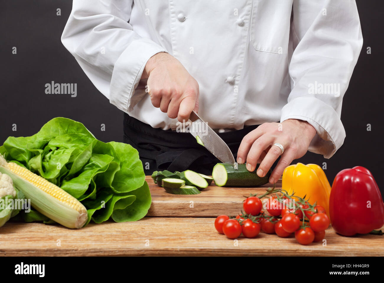 Photo d'un cuisinier, hacher les légumes sur une planche à découper en bois  Photo Stock - Alamy