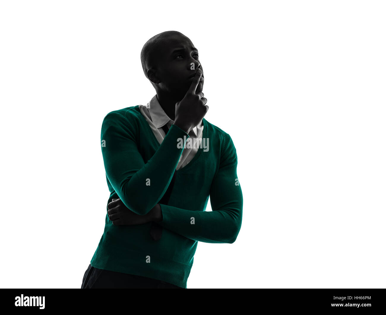 Un homme noir africain pense pensive en silhouette studio sur fond blanc Banque D'Images