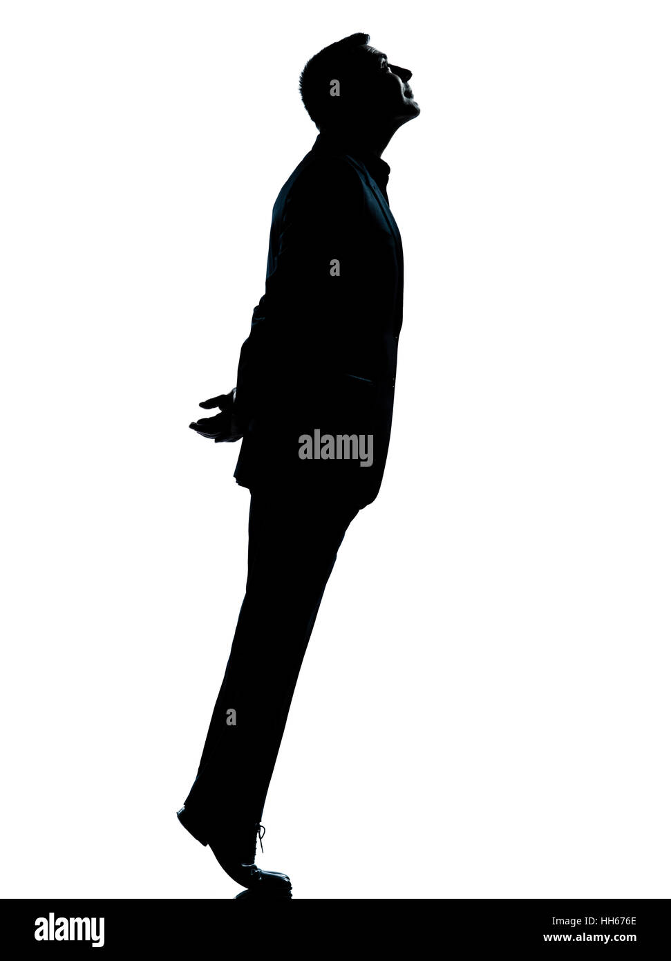 Un homme d'affaires de race blanche des pieds jusqu'à la silhouette debout en pleine longueur studio isolé sur fond blanc Banque D'Images