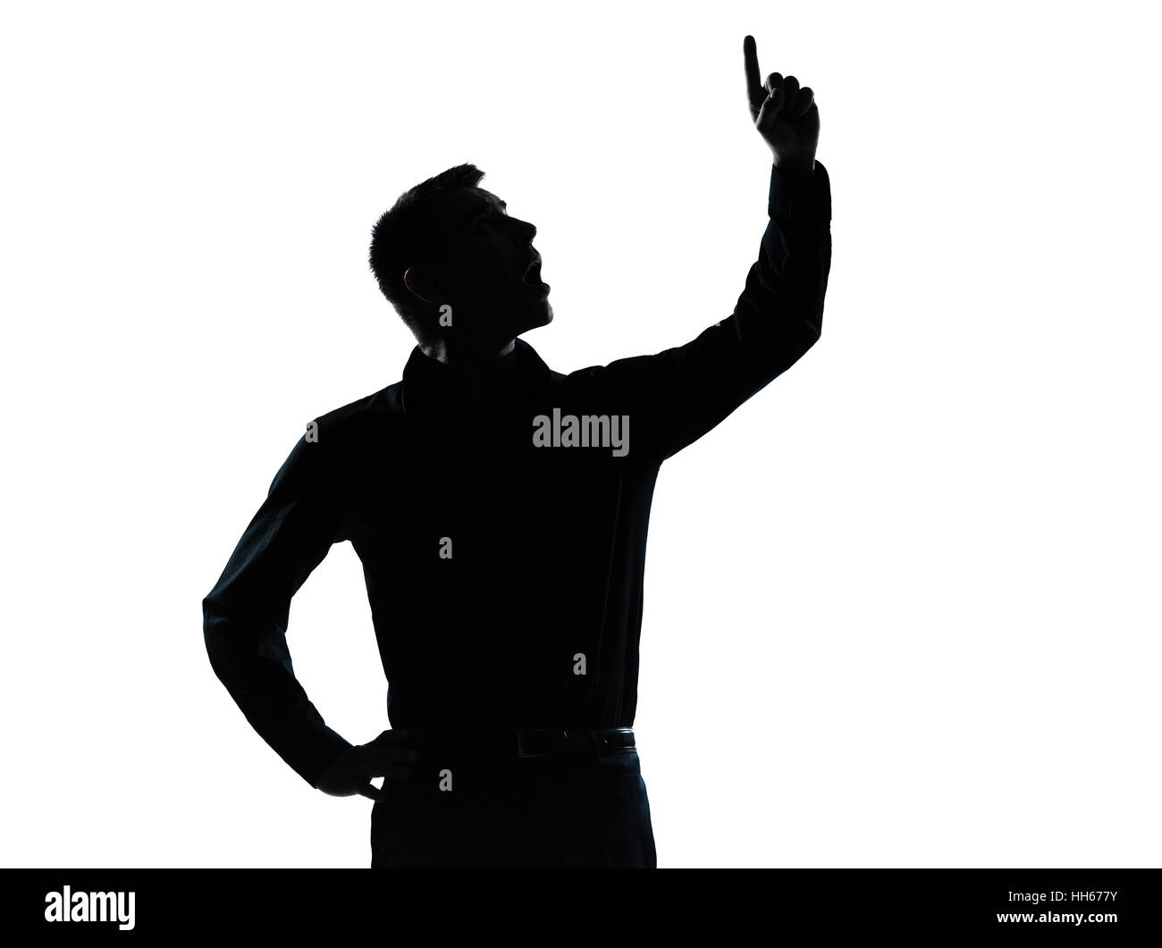 Un caucasian business man pointing up surpris en silhouette portrait studio isolé sur fond blanc Banque D'Images