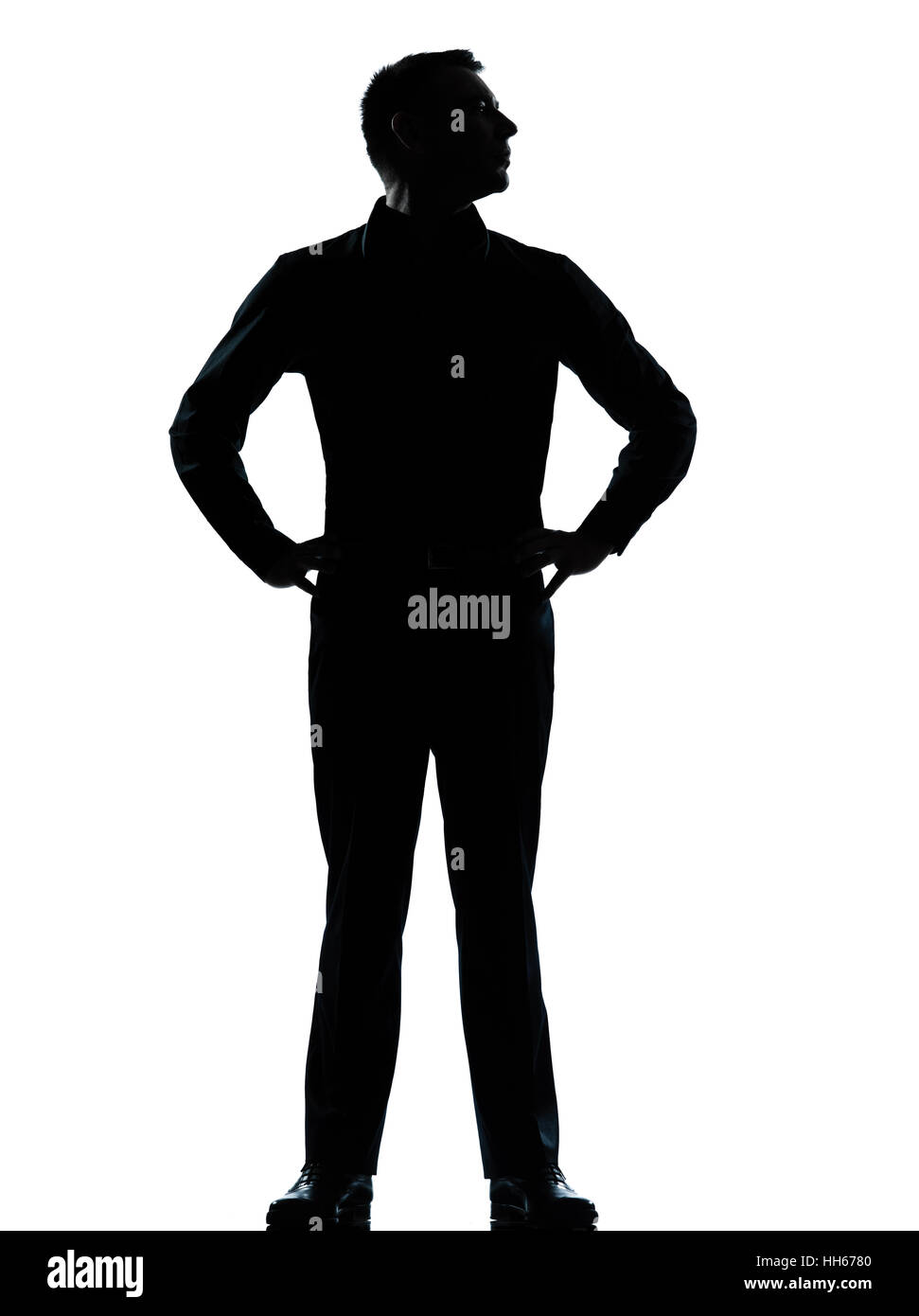 Un caucasian business man silhouette debout les mains sur les hanches en pleine longueur studio isolé sur fond blanc Banque D'Images