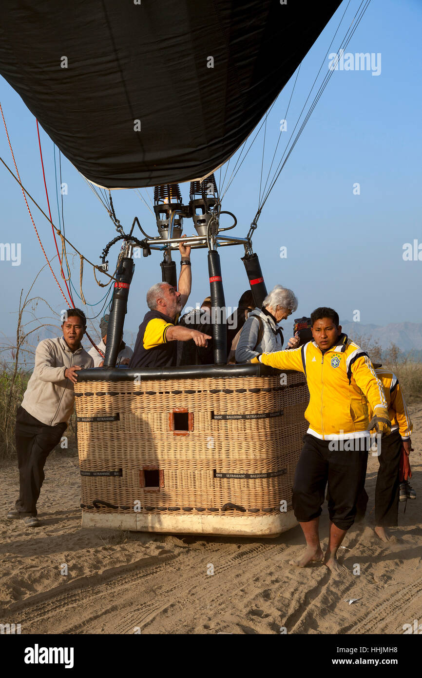Après l'atterrissage, le positionnement d'un ballon par l'équipage dans un endroit protégé du vent et des arbustes épineux (Old Bagan - Myanmar). Banque D'Images