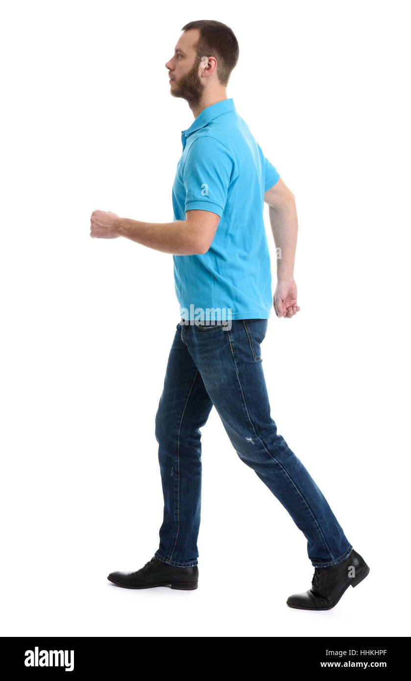 Homme barbu occasionnels portant des jeans et polo walking over white background Banque D'Images