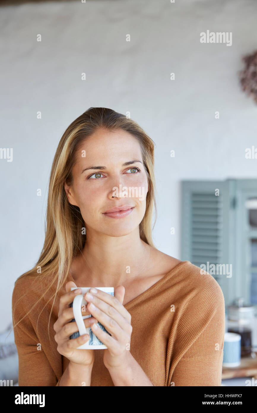 Serene woman drinking coffee together on patio Banque D'Images