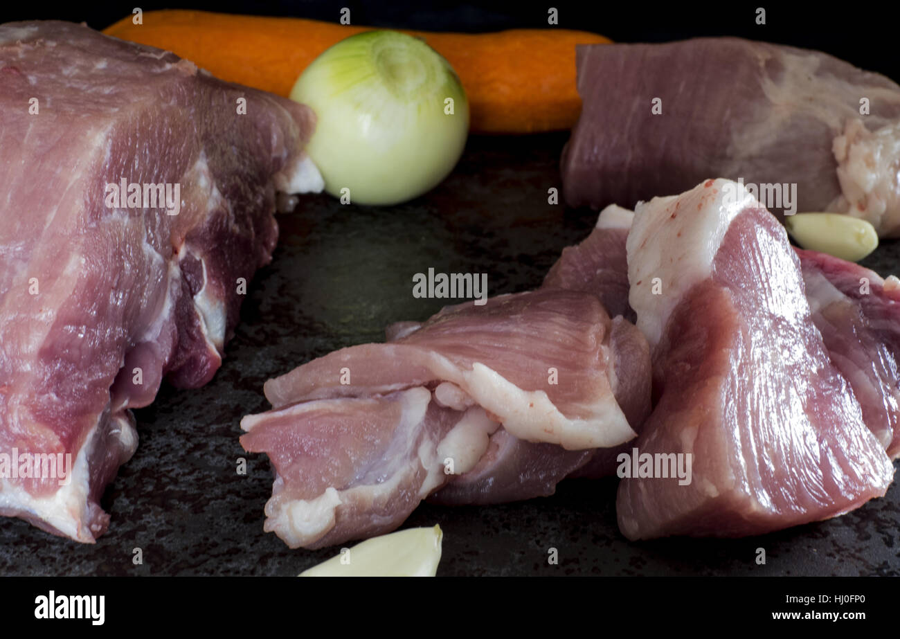 Commune de matières premières de viande de porc, l'oignon, l'ail et la carotte sur pierre sombre arrière-plan. 21 Jan, 2017. Crédit : Igor Golovniov/ZUMA/Alamy Fil Live News Banque D'Images