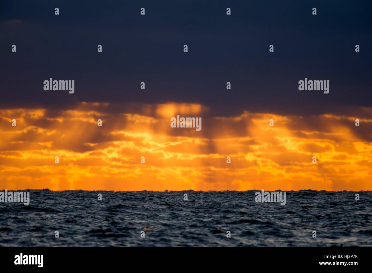 Un ciel d'orage crée un lever de soleil sur l'océan Atlantique. Banque D'Images
