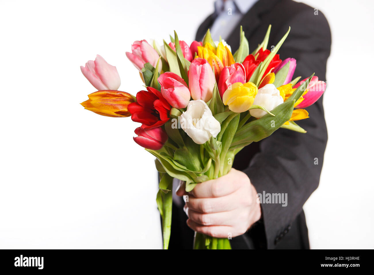 Homme la main avec bouquet de tulipes, isolé sur fond blanc Banque D'Images