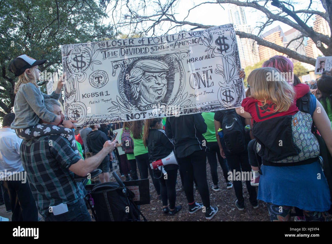 Austin, Texas, États-Unis. 21 janvier, 2017. Un billet d'un dollar avec bannière Président Trump est porté par les manifestants pendant une Anti-Trump Inarguration manifestation le jour, Austin, Texas Credit : Sandy Carson/ZUMA/Alamy Fil Live News Banque D'Images