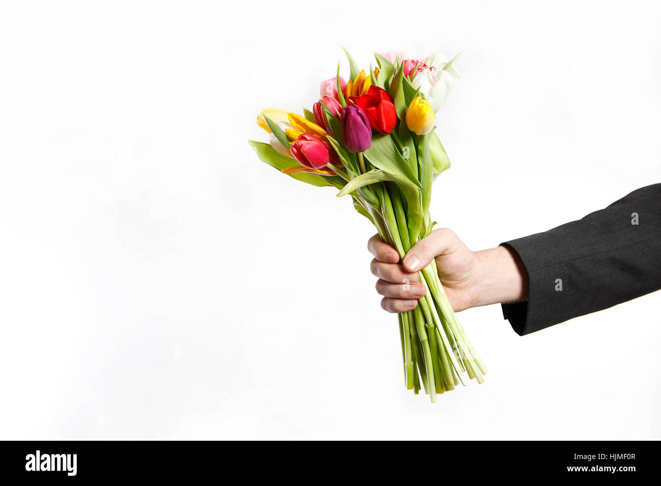 Homme la main avec bouquet de tulipes, isolé sur fond blanc Banque D'Images