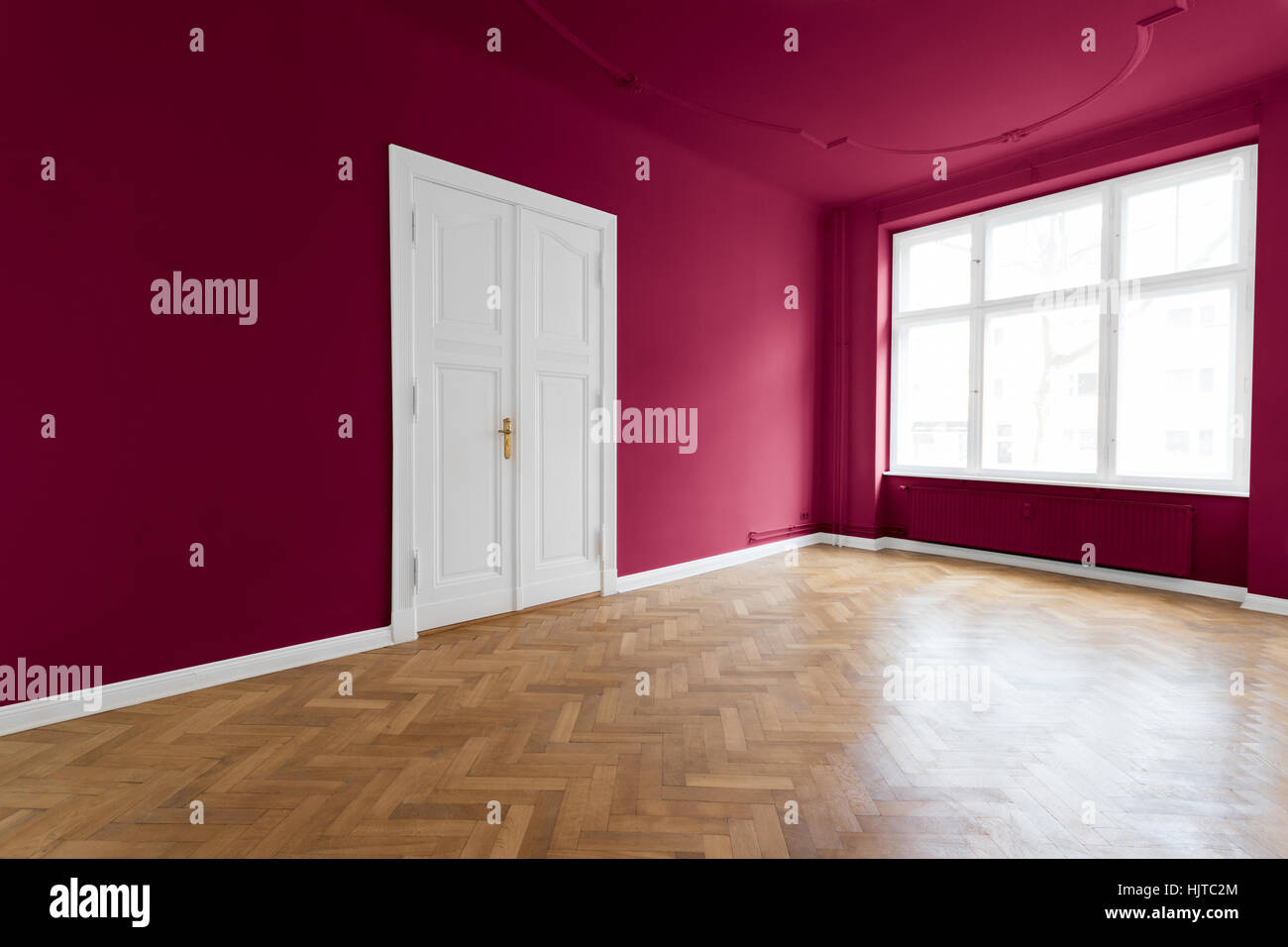 Salle vide avec plancher en bois, murs peints en rouge Banque D'Images