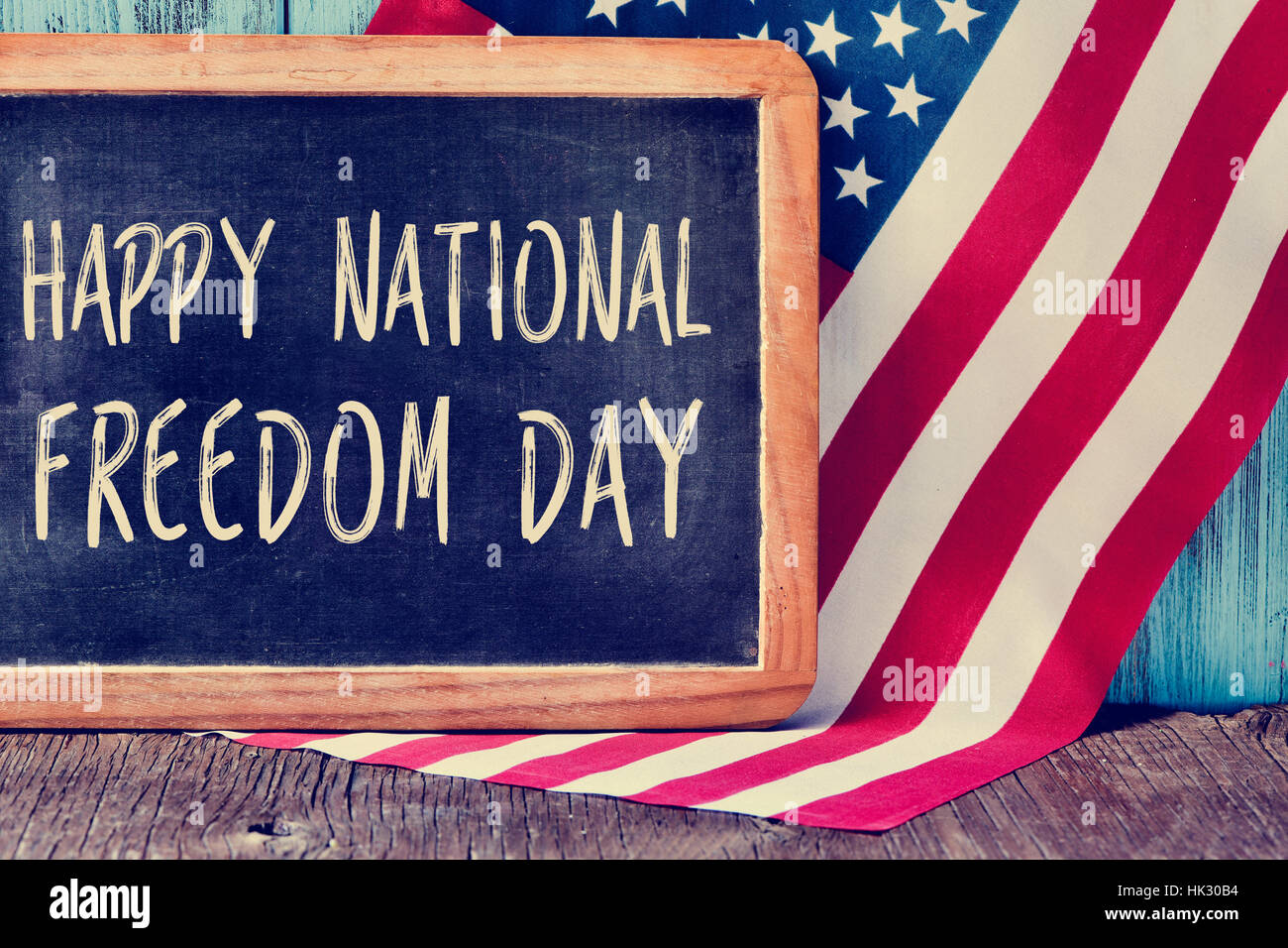 La journée de la liberté nationale heureux texte écrit dans un tableau noir et un drapeau des États-Unis, sur un fond de bois rustique Banque D'Images