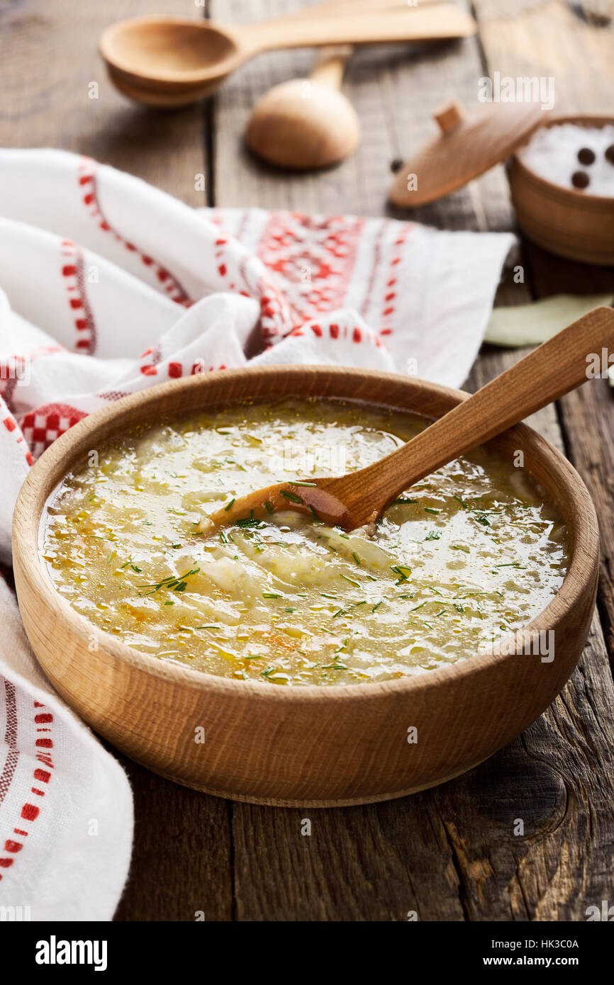 Soupe kapusniak choucroute ukrainien avec mil sur table rustique à bol en bois, soupe d'hiver traditionnel Banque D'Images