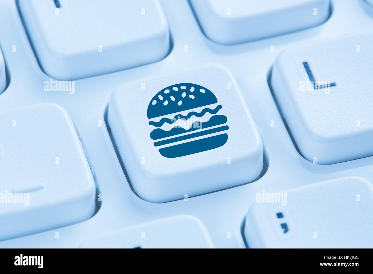 Ordinateur hamburger cheeseburger fast food livraison de commande en ligne de commande clavier bleu symbole Banque D'Images