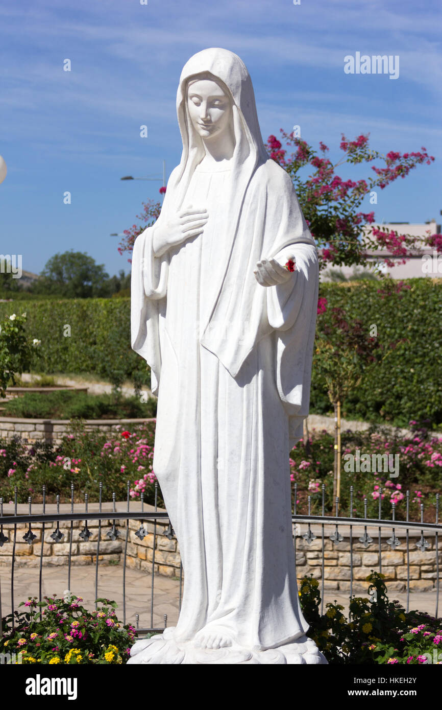 Statue de Vierge Marie en face de l'église de Saint James. Elle invite ses enfants à prier. MEDJUGORJE, BOSNIE ET HERZÉGOVINE, 2016/08/20. Banque D'Images