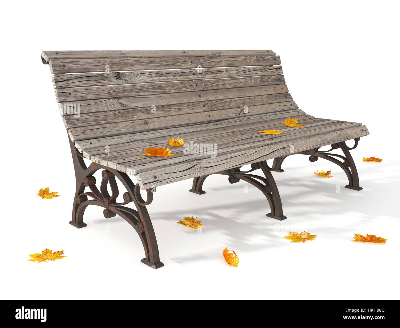 Banc en bois avec des feuilles jaunes secs isolés sur le terrain Banque D'Images