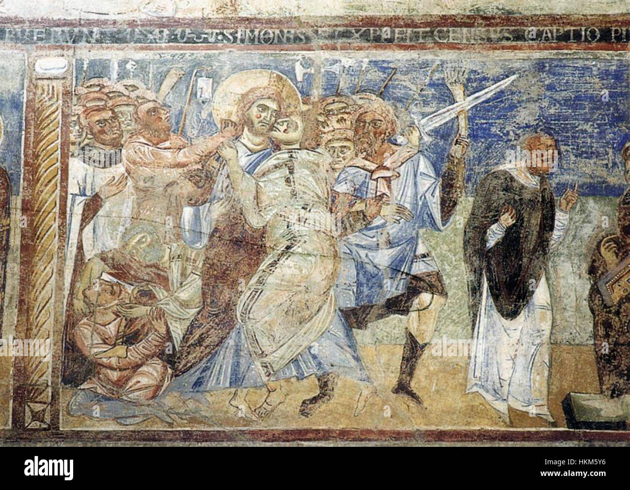 Cette peinture du XIe siècle, créée par un artiste inconnu, représente la *trahison du Christ* par Judas. La scène capture le moment charnière de l'arrestation de Jésus, mettant en valeur l'art chrétien primitif avec des éléments symboliques de trahison, de sacrifice divin et de préfiguration de la crucifixion du Christ. Banque D'Images