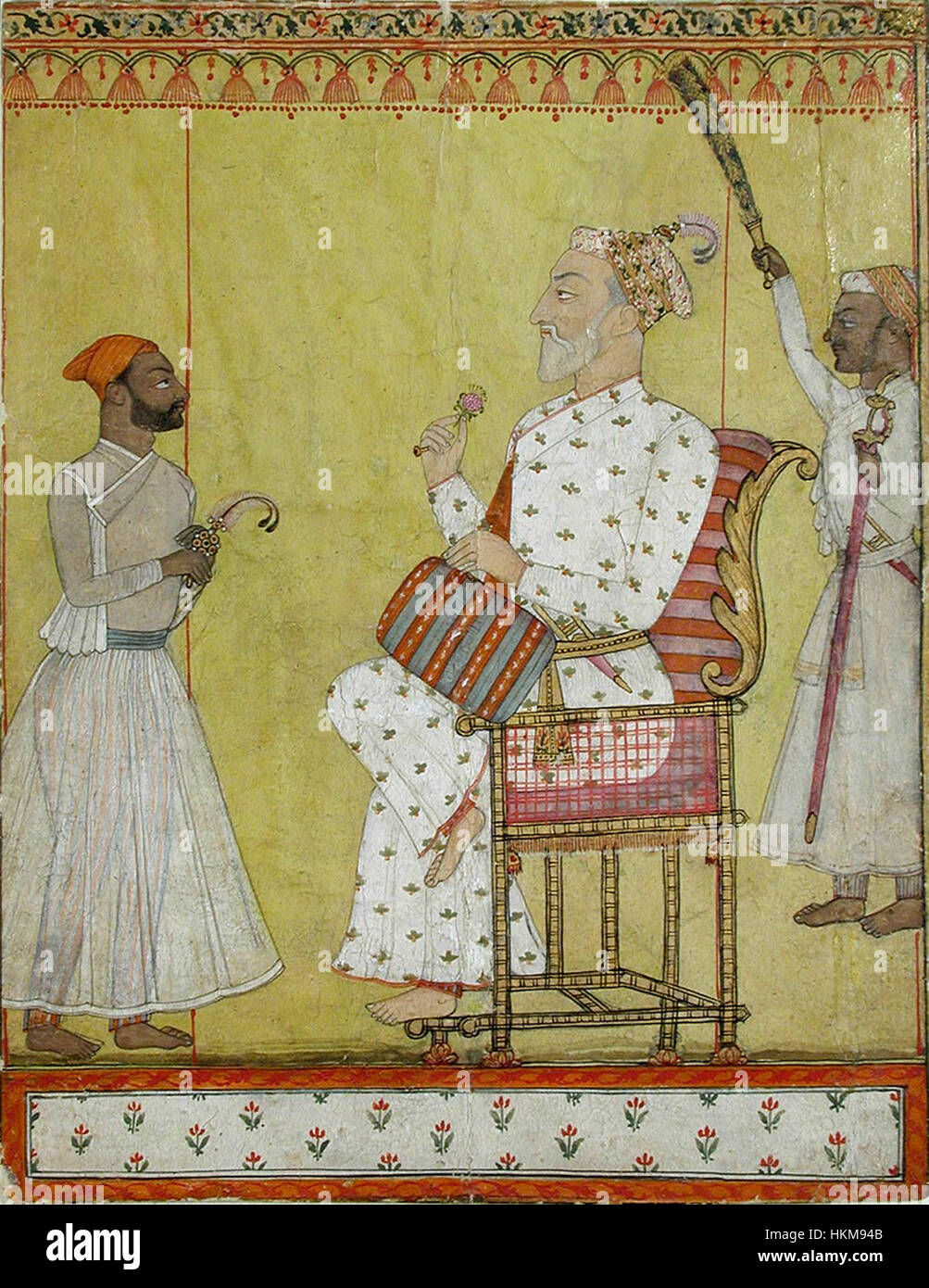 Tableau représentant un souverain assis sur un trône, tenant une rose, assisté par un porteur de chauri, saluant un visiteur, mettant en valeur les vêtements traditionnels et les coutumes royales. Banque D'Images