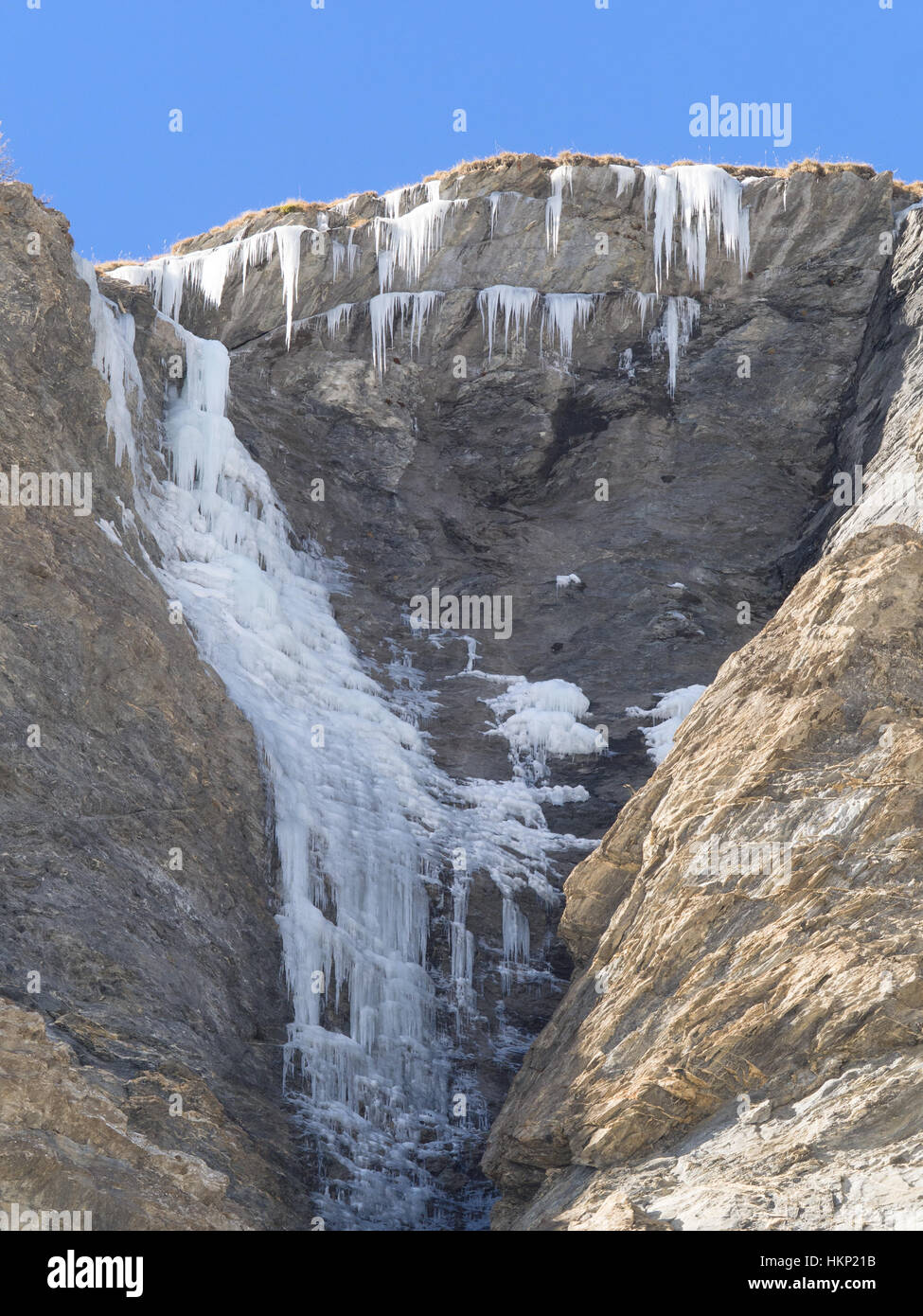 Cascade de glace et des stalactites de glace sur un rocher dans une montagne d'Alpes européennes Banque D'Images
