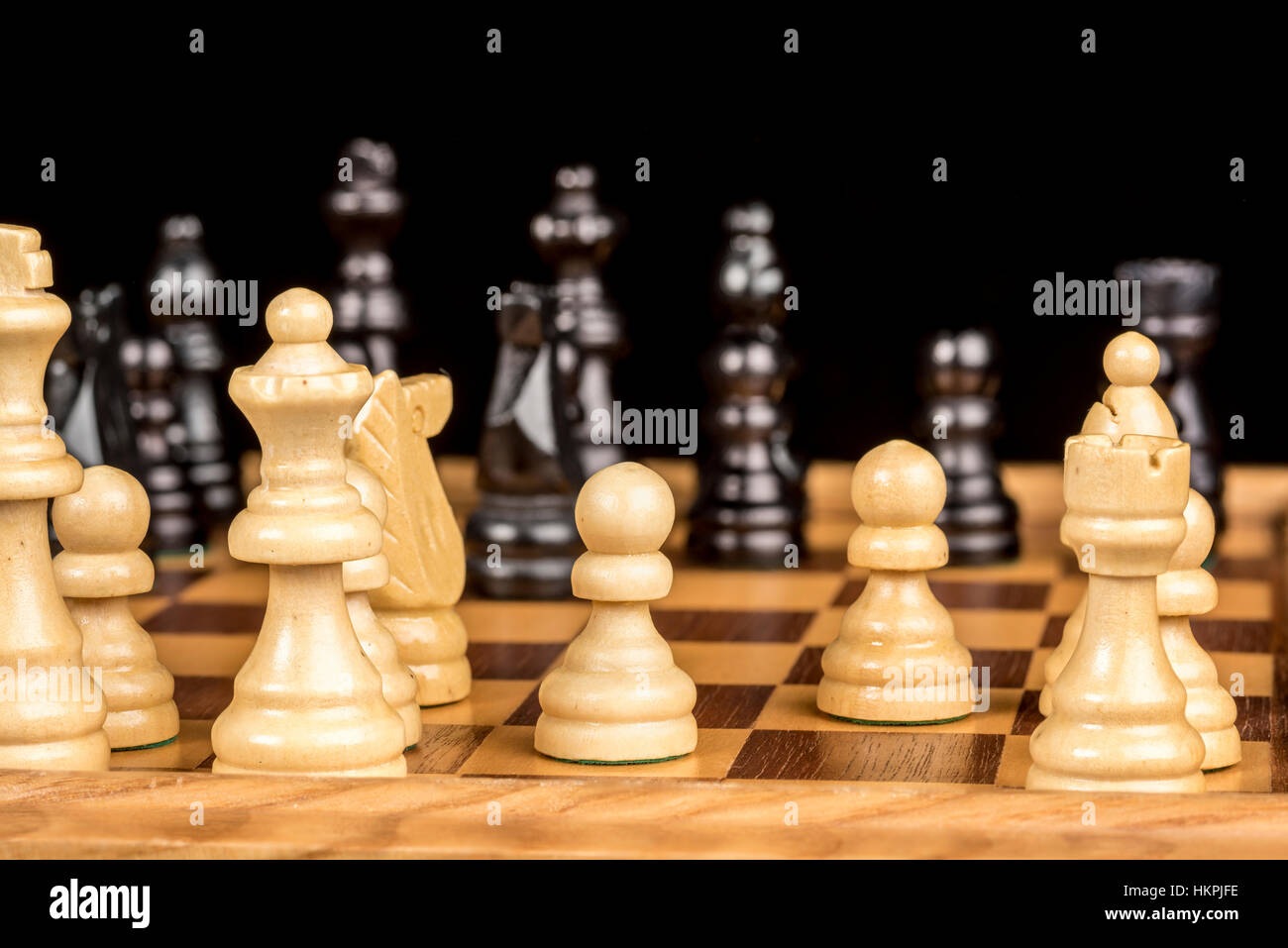 Pièces des échecs en bois sur un plateau de jeu prêt à jouer Banque D'Images