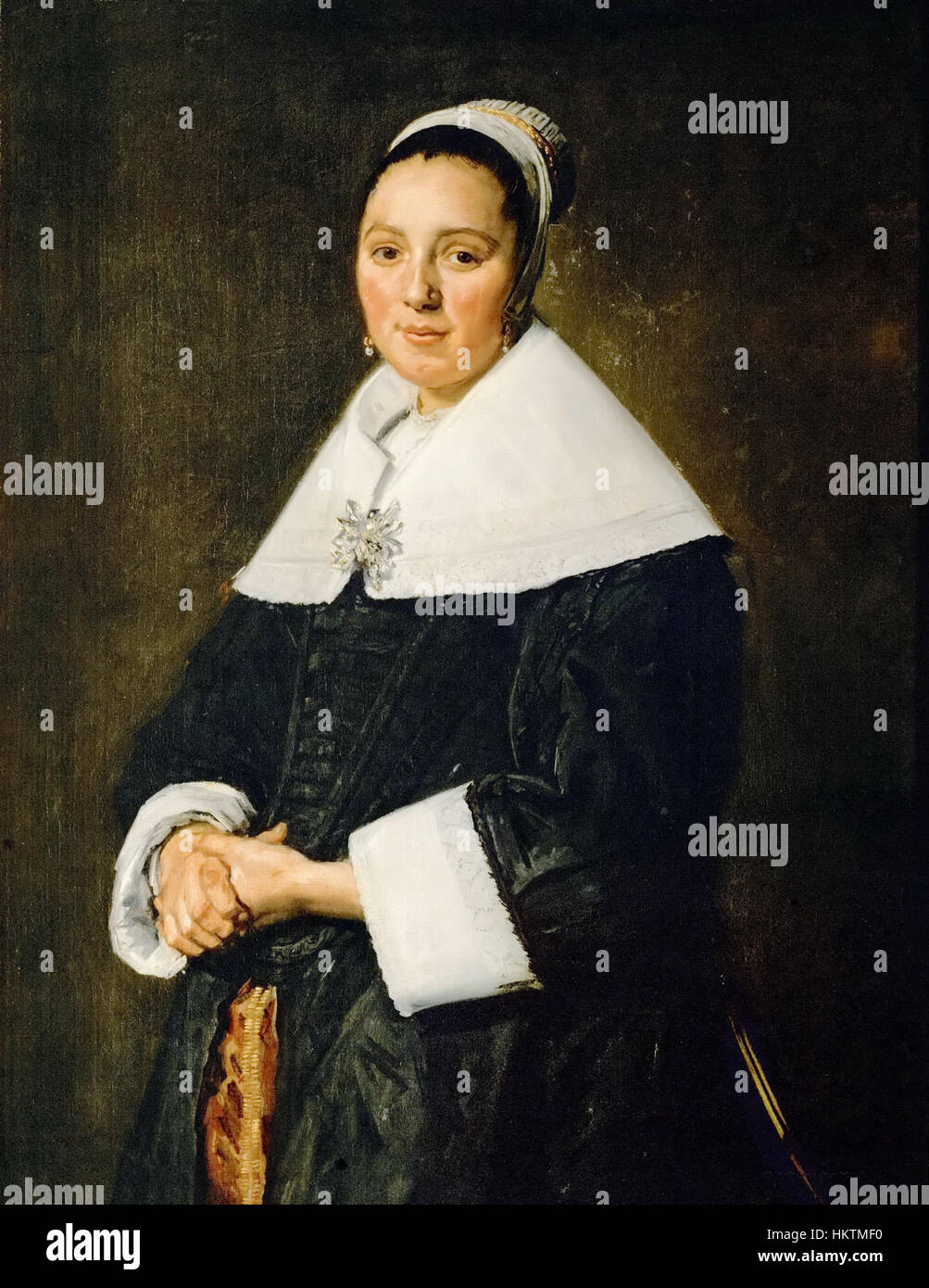 'Portret van een vrouw' de Frans Hals est une peinture à l'huile du milieu du XVIIe siècle représentant une femme avec des coups de pinceau détaillés et expressifs. La peinture capture le caractère vivant et personnel du sujet, une caractéristique du style de Hals. Banque D'Images