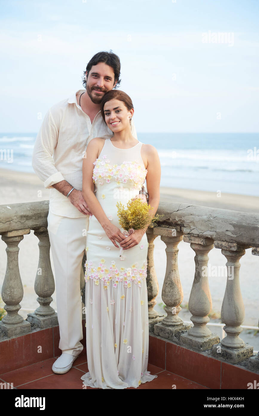 Heureux mariage pose smiling couple sur fond de mer Banque D'Images