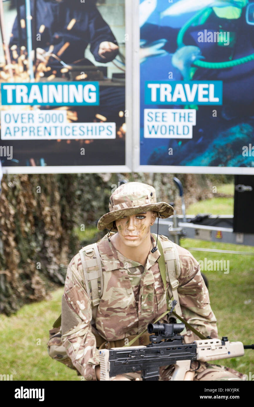 Conseils de recrutement de l'Armée britannique et d'un mannequin habillé en uniforme de camouflage avec sa carabine80 Banque D'Images
