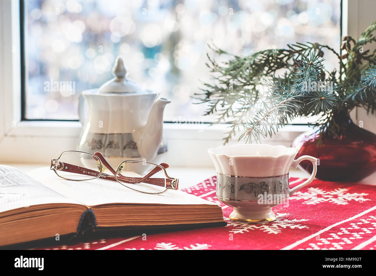 La vie encore d'hiver : open book, verres, verre, tasse de thé et l'arbre de Noël dans un vase. Focus sélectif. Décoration d'intérieur, vous pourrez vous détendre concept Banque D'Images
