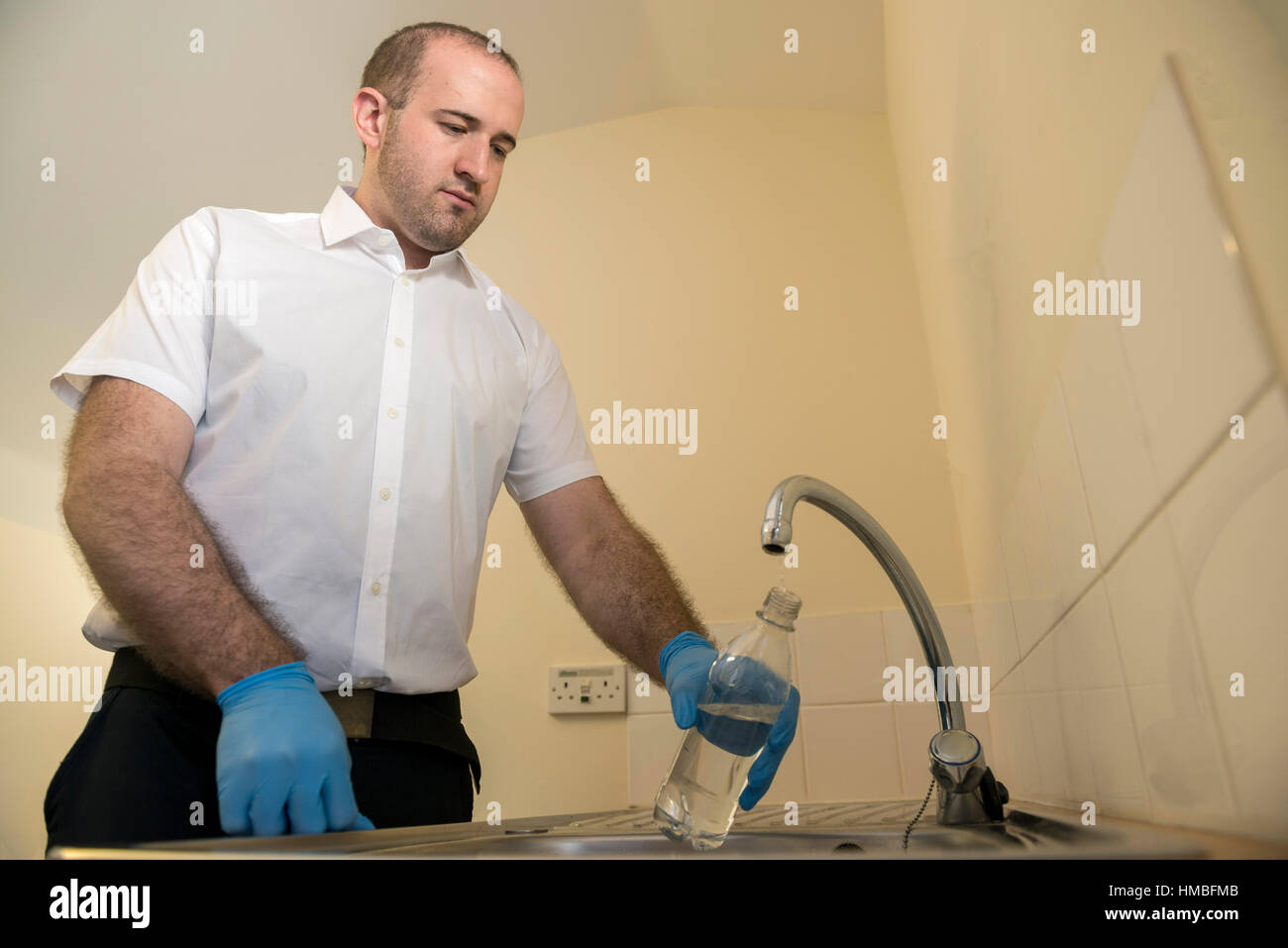 Santé et la sécurité des techniciens de laboratoire vérifier des immeubles et des propriétés sur les dangers pour l'environnement, tels que l'amiante et de la qualité de l'eau avec équipement correct Banque D'Images